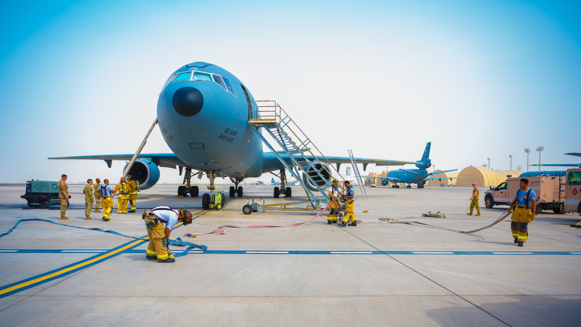 U.S. Air Force Airmen of the 380th Expeditionary Fire Department perform an exercise involving a KC-10 Extender aircraft at Al Dhafra Air Base, United Arab Emirates.