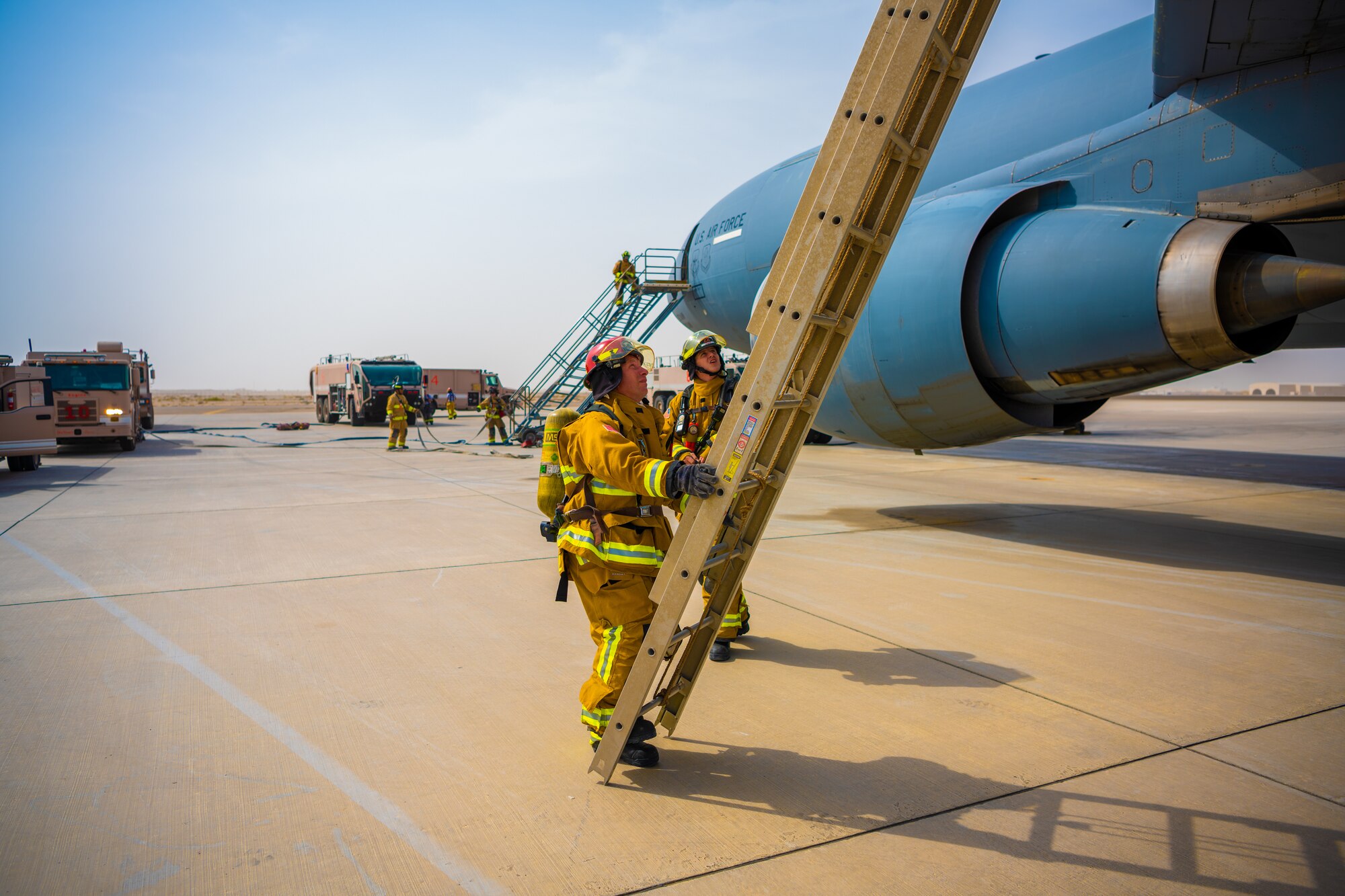 U.S. Air Force Airmen of the 380th Expeditionary Fire Department perform an exercise involving a KC-10 Extender aircraft at Al Dhafra Air Base, United Arab Emirates.