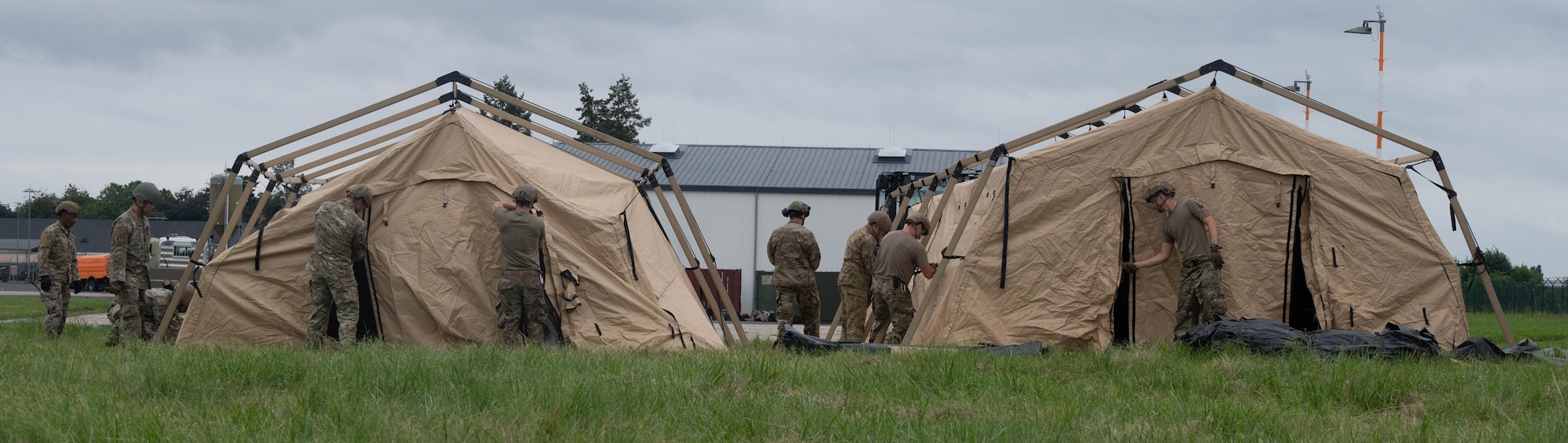 Airmen assemble tents.