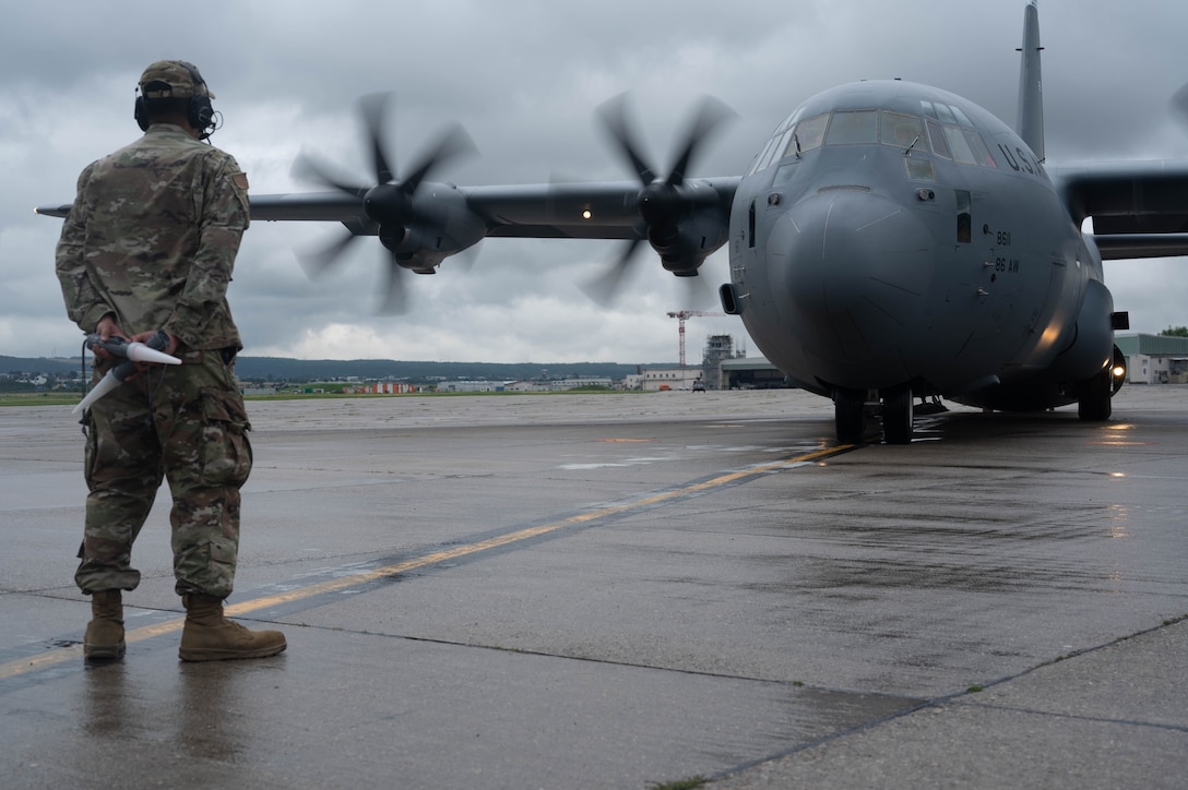 An Airman prepares to marshal a C-130.