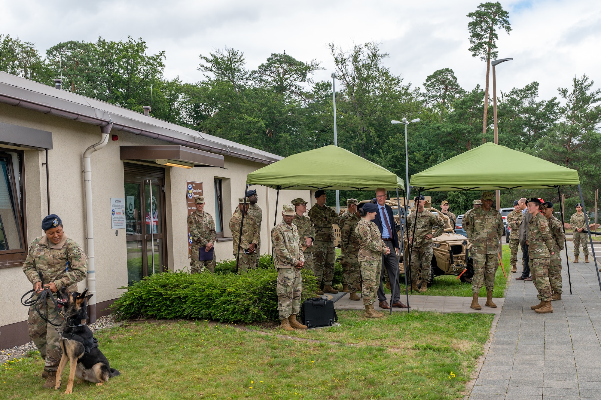 Group of Airmen and the CSAF watching a military working dog exercise.