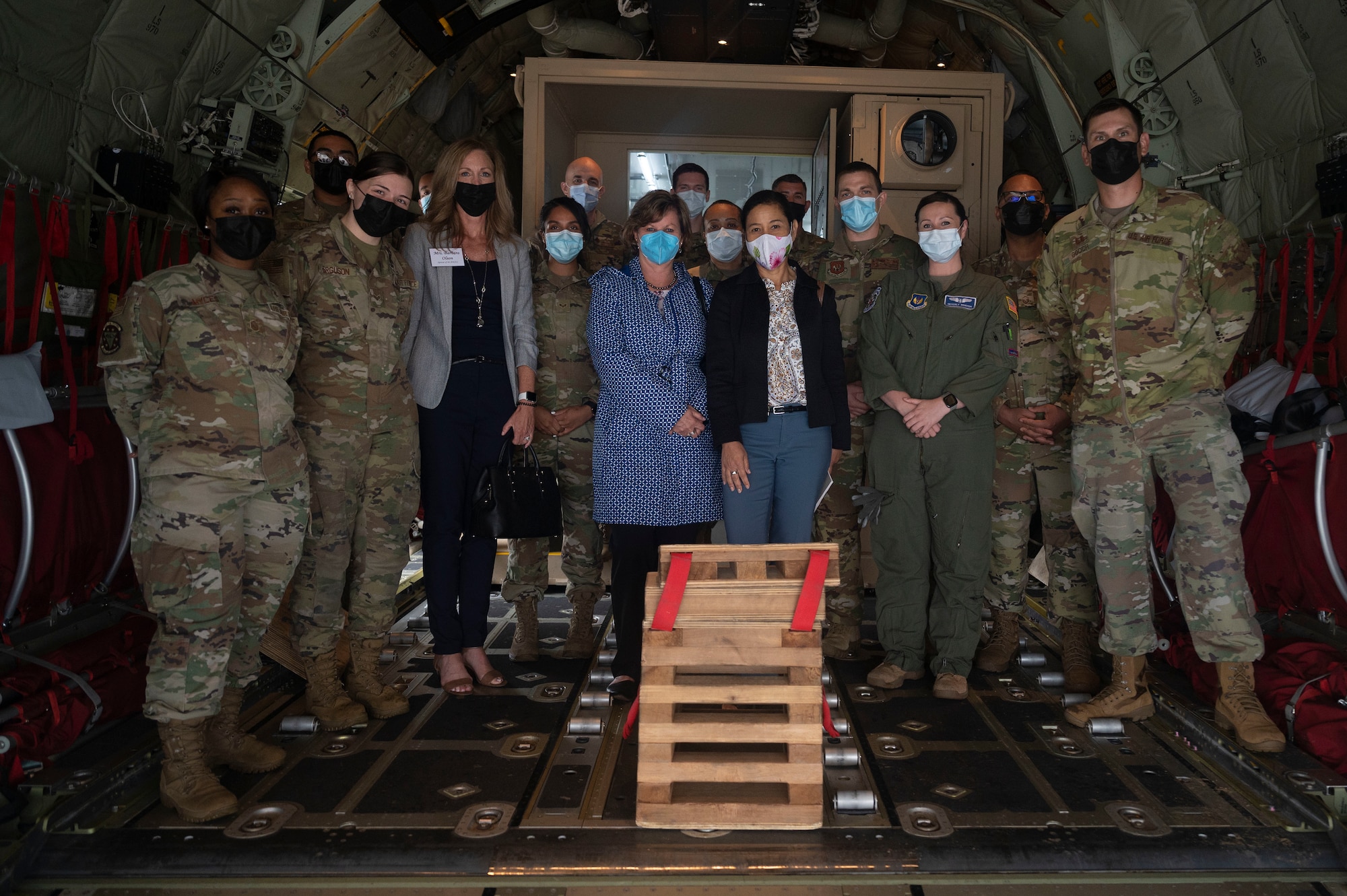 Mrs. Sharene Brown, middle right, takes a group photo with Airmen assigned to the 86th Aeromedical Evacuation Squadron at Ramstein Air Base, Germany, July, 14, 2021. Mrs. Brown was briefed on the 86th AES’s COVID-19 patient transport procedures