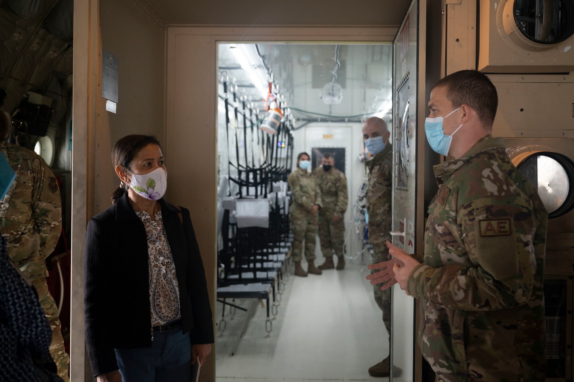 Mrs. Sharene Brown, receives a COVID-19 patient transport briefing from U.S. Air Force Maj. Joshua Williams, 86th Aeromedical Evacuation Squadron operations flight commander, on a C-130J Super Hercules aircraft