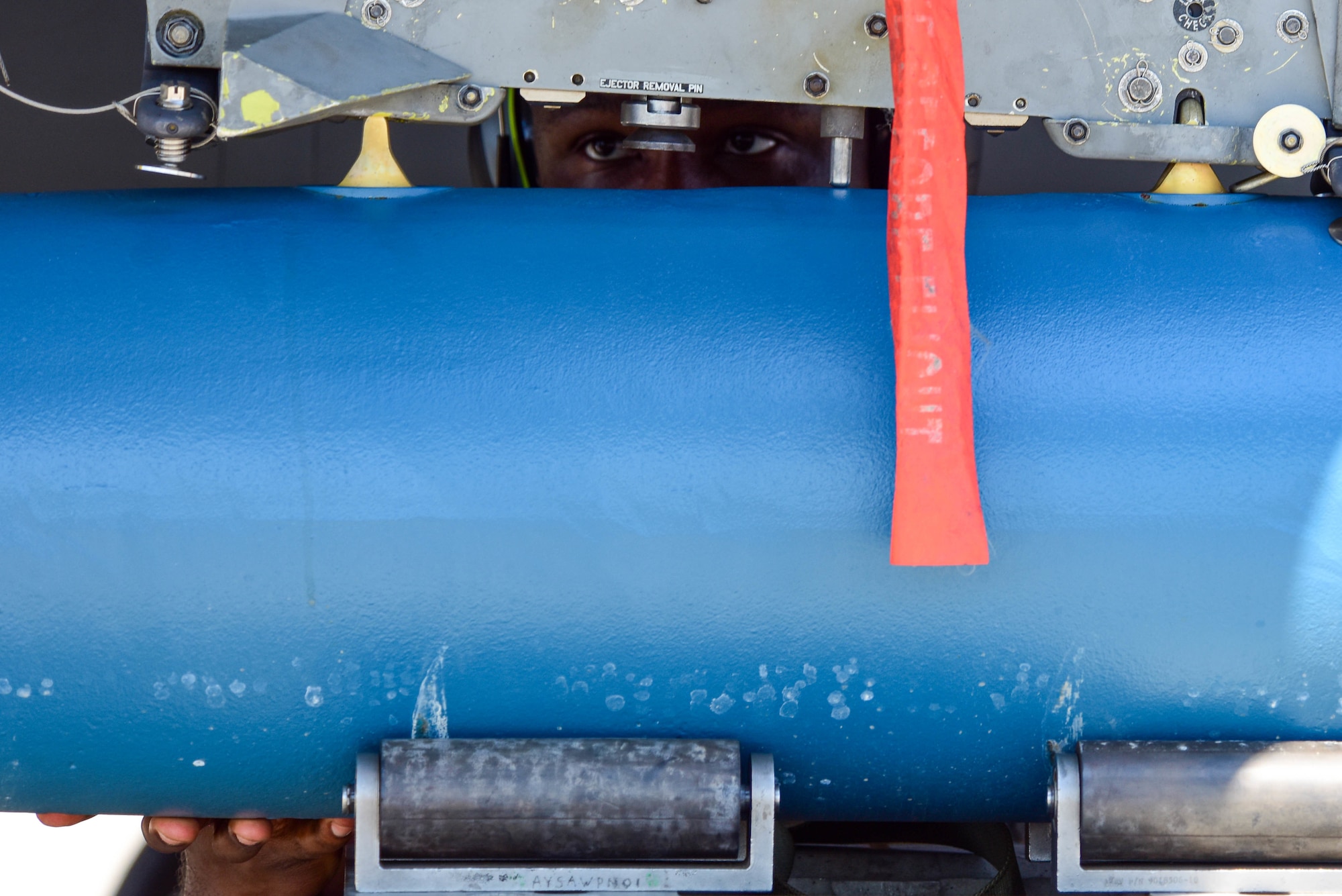 A weapons load crew member assigned to the 555th Aircraft Maintenance Unit prepares to load a munition onto a U.S. Air Force F-16 Fighting Falcon during the Bulgarian air force-led  exercise Thracian Star 21 at Graf Ignatievo Air Base, Bulgaria, July 12, 2021. Exercises such as Thracian Star 21 provide both U.S. Airmen and Bulgarian forces an opportunity to extend joint warfighting capability through operational and tactical training. (U.S. Air Force photo by Airman 1st Class Brooke Moeder)