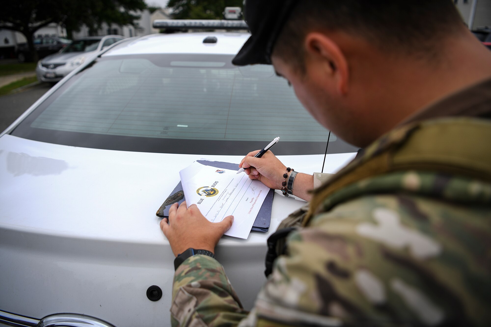 Security Force Airman fills out a certificate