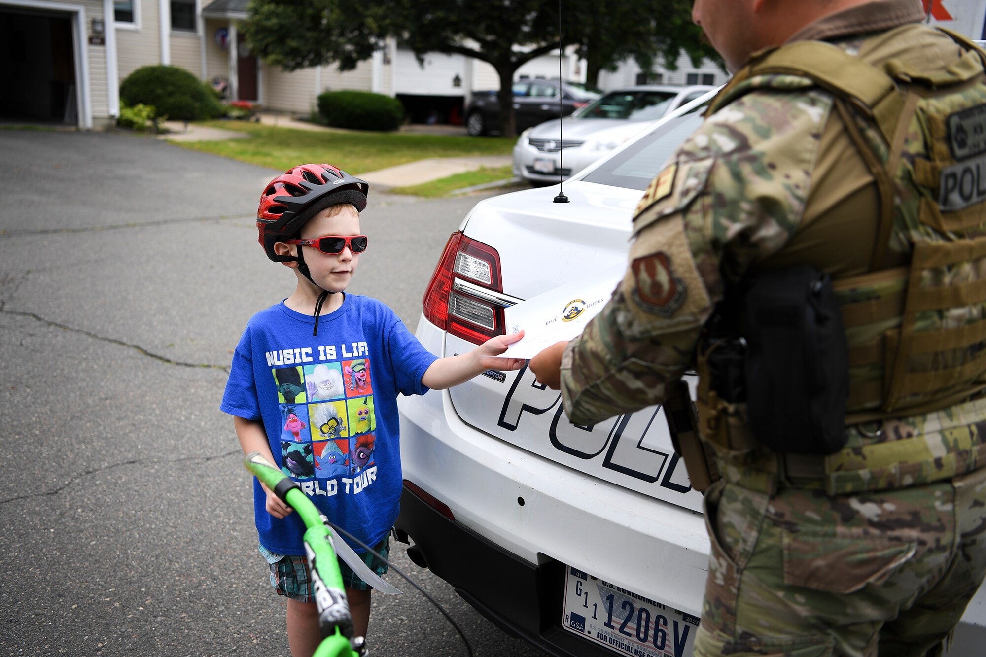 Photo of a Security Forces Airman and child on a bicycle