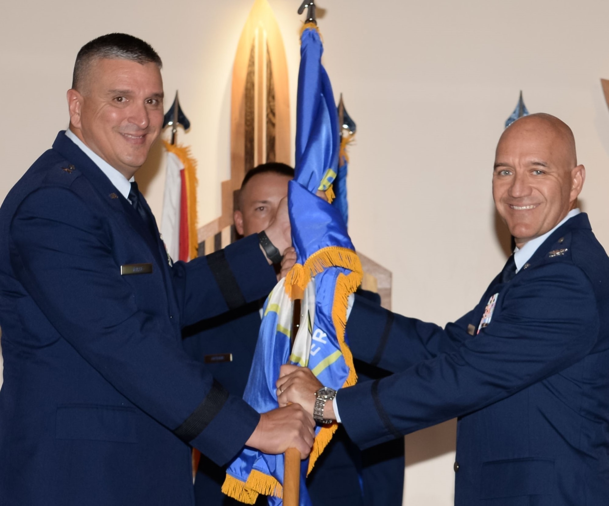 U.S. Air Force Col. Randolph Lake, right, incoming 101st Air and Space Operations Group (AOG) commander, accepts the ceremonial passing of the flag from Brig. Gen. Michael Valle, Air, Florida National Guard assistant adjutant general, and Florida Air National Guard commander, during an AOG change of command, Tyndall Air Force Base, July 14, 2021.