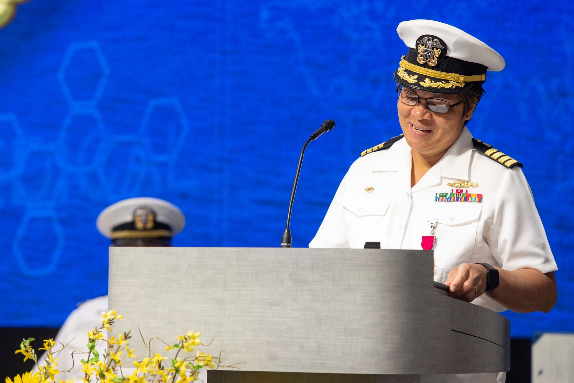 U.S. Navy Capt. Nimfa Teneza-Mora, outgoing commander of Naval Medical Research Unit Dayton, delivers remarks during the Naval Medical Research Unit Dayton change of command ceremony, July 9, 2021, at Wright Patterson Air Force Base, Ohio. NAMRU-Dayton is one the premier research facilities in the Navy and the unit has contributed significantly to understanding health, safety, and performance consequences of flight on humans. (U.S. Air Force photo by Wesley Farnsworth)