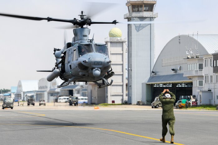 Staff Sgt. Gustavo Lopez, a Plane Captain assigned to the “Vipers” of Marine Light Attack Helicopter Squadron 169, guides an UH-1Y Venom as it arrives at Naval Air Facility Misawa. HMLA-169 is at NAF Misawa to conduct Tilt Rotor/Rotary Wing training exercises and reduce the training activity impact on Okinawa.