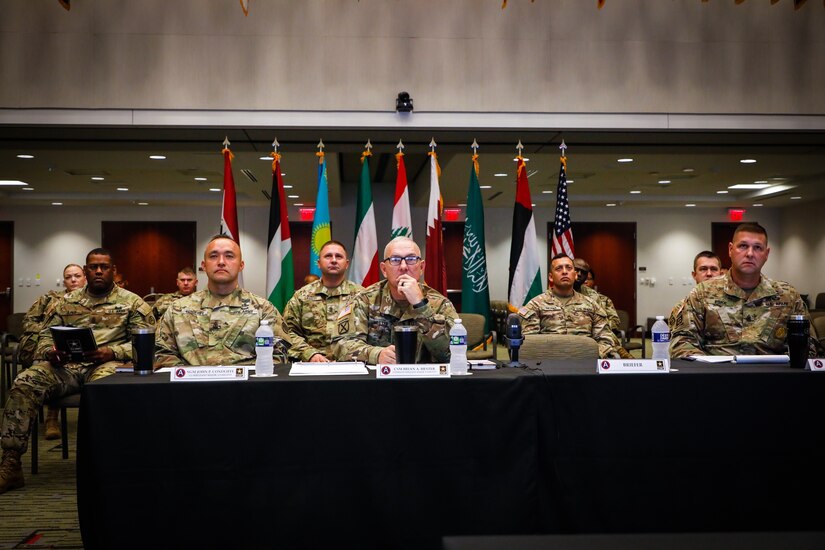 U.S. Army Central Command Sgt. Maj. Brian Hester and staff Sgts. Maj. remain attentive as someone speaks during the USARCENT Land Forces NCO Symposium, July 14, 2021 in the Lucky Conference Room at USARCENT headquarters on Shaw Air Force Base, S.C. This annual symposium was held to solidify relationships and increase the capacity of professionalism of our partner nations NCO Corps. (U.S. Army photo by Spc. Keon Horton)