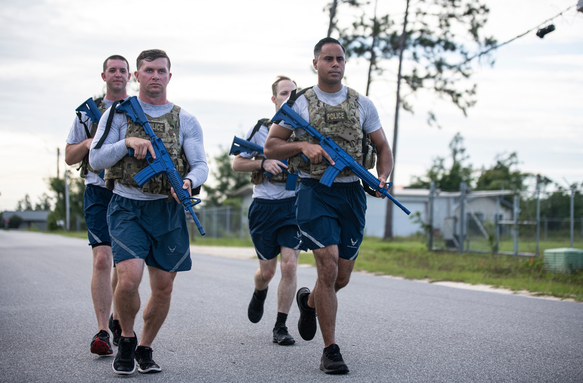 Members of the 325th Security Forces Squadron tactical response team run in formation at the Bay County Sheriff’s Office, Panama City, Florida, July 13, 2021. The 325th SFS is determining the effectiveness of standing up a specialized security forces team that trains with local police departments to handle high-threat situations, such as barricaded suspects, hostage situations and mass shootings. (U.S. Air Force photo by Staff Sgt. Stefan Alvarez)