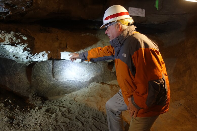 The U.S. Army Engineer Research and Development Center's Cold Regions Research and Engineering Laboratory Director Dr. Joseph Corriveau identifies the transition between ice wedge material and ice cemented silt in the U.S. Army Corps of Engineers Permafrost Tunnel Research Facility.
