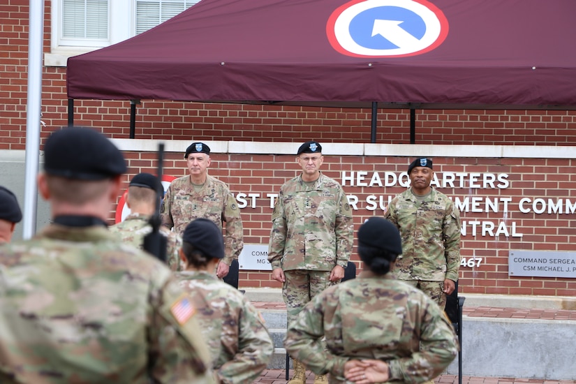 From left to right - Maj. Gen. John P. Sullivan, outgoing commanding general, 1st Theater Sustainment Command,  Lt. Gen. Terry R. Ferrell, commanding general, U.S. Army Central, and Maj. Gen. Michel M. Russell Sr., incoming commanding general, 1st TSC, look out at the formation during the 1st TSC change of command ceremony held July 13, 2021 outside of Fowler Hall at Fort Knox, Kentucky. Maj. Gen. Michel M. Russell Sr. assumed command of the 1st TSC from Maj. Gen. John P. Sullivan before an audience of current and former leaders, community members, family, and 1st TSC Soldiers. (U.S. Army Photo by Spc. Zoran Raduka)