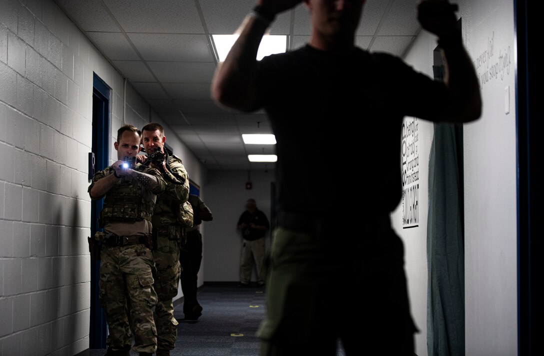 U.S. Air Force Staff Sgts. Logan Johnson and Kyle Johnson, 325th Security Forces Squadron tactical response team members, give instructions to a simulated suspect during a training exercise in Panama City, Florida, July 13, 2021. The 325th SFS is testing the effectiveness of standing up its own specialized team to handle high-threat situations where they are better trained and equipped than the standard first responder. (U.S. Air Force photo by Staff Sgt. Stefan Alvarez)