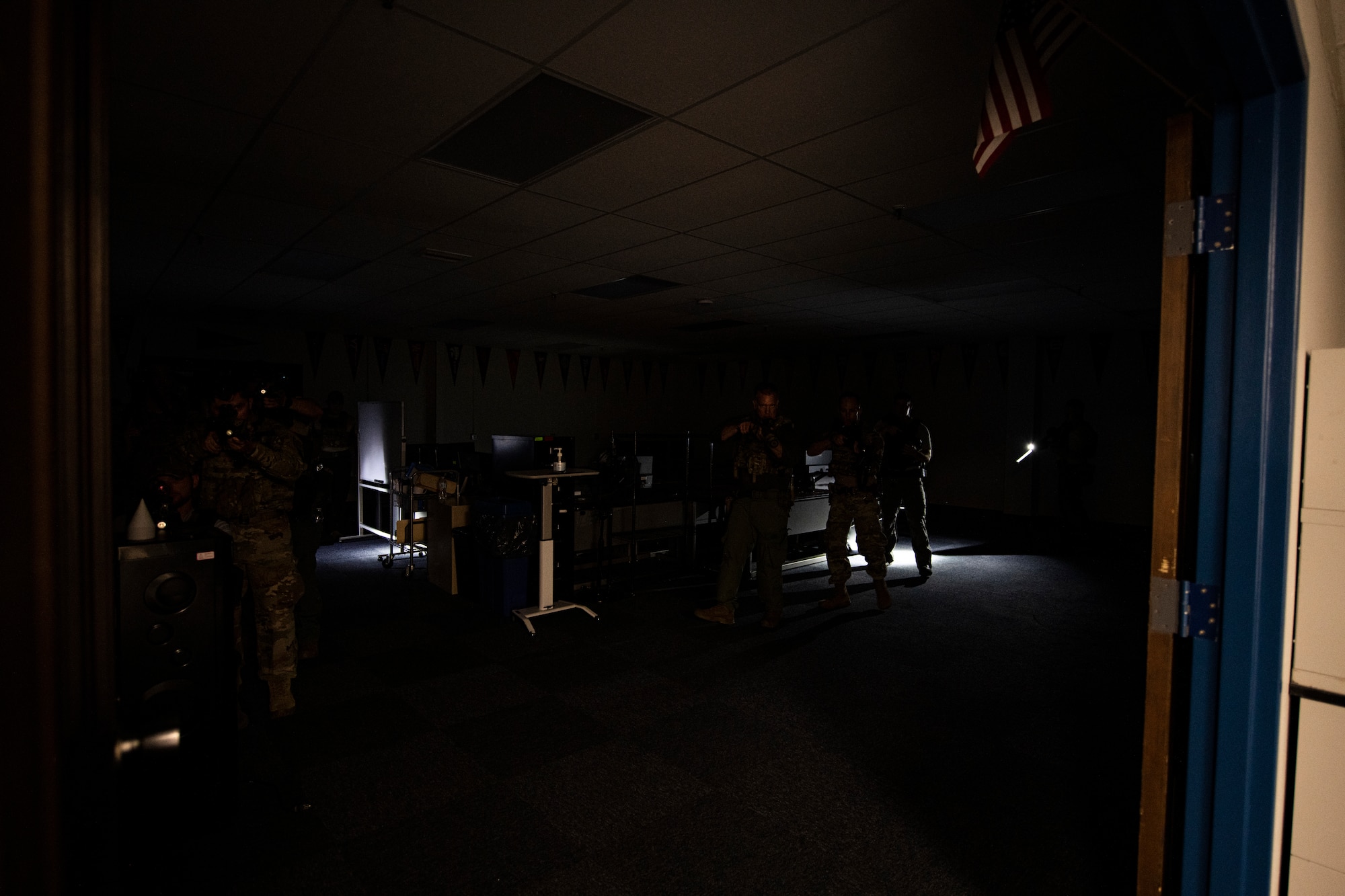 Members of the Bay County Sheriff’s Office special weapons and tactics team and 325th Security Forces Squadron tactical response team clear a room during a training exercise in Panama City, Florida, July 13, 2021. Simulated suspects were hidden throughout the building requiring the SFS and BCSO teams to work together to safely and efficiently find them. (U.S. Air Force photo by Staff Sgt. Stefan Alvarez)