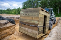 A U.S. Marine Corps TRAM 624KR Tractor with 8th Engineer Support Battalion, 2nd Marine Logistics Group, transports a Combat Operations Center during a field exercise on July 14, 2021 at Camp Lejeune, North Carolina. The Marines built an underground COC to hide from a simulated enemy in a contested environment. (U.S. Marine Corps photo by Cpl. Christian M. Garcia)