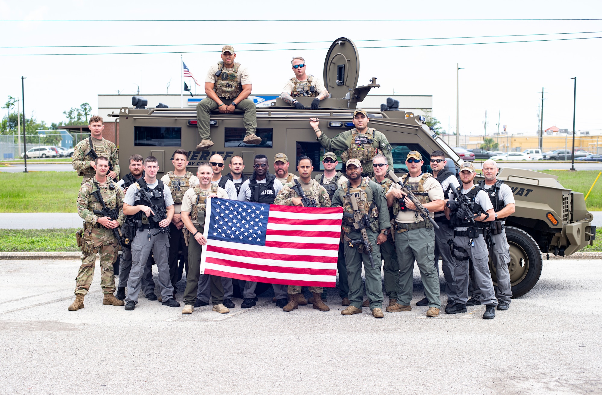 Members from the 325th Security Forces Squadron tactical response team and Bay County Sheriff’s Office and Panama City Police Department special weapons and tactics teams pose for a photo in Panama City, Florida, July 13, 2021. The three agencies trained together to share tactics and experience from both military and civilian police careers in order to become more well-rounded units. (U.S. Air Force photo by Staff Sgt. Stefan Alvarez)