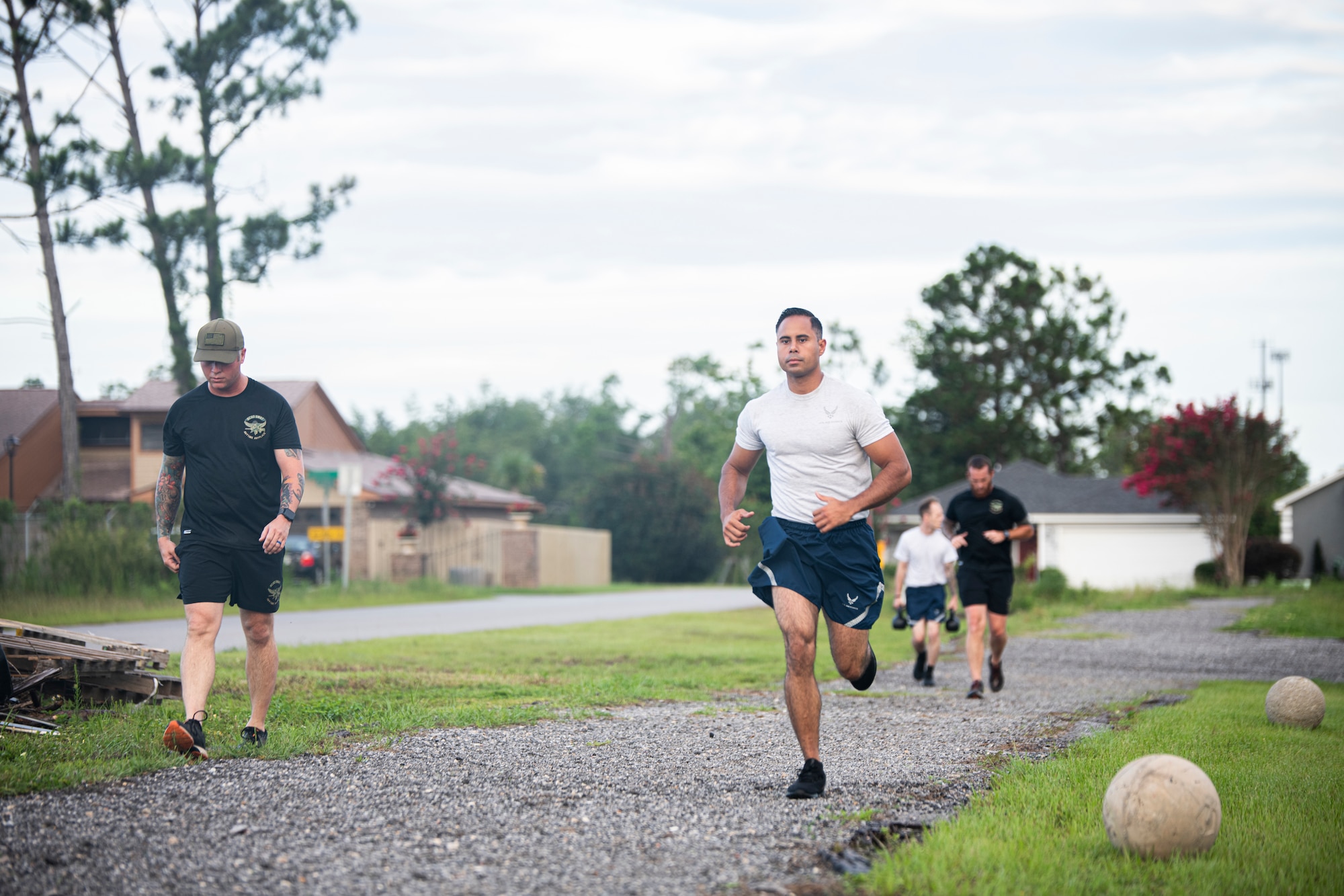 U.S. Air Force Tech. Sgt. Gabriell Vieira, 325th Security Forces Squadron tactical response team noncommissioned officer in charge, center, runs around a track at the Bay County Sheriff’s Office, Panama City, Florida, July 13, 2021. The 325th SFS is determining the effectiveness of standing up a specialized team that trains with local police departments to handle high-threat situations, such as barricaded suspects, hostage situations and mass shootings. (U.S. Air Force photo by Staff Sgt. Stefan Alvarez)