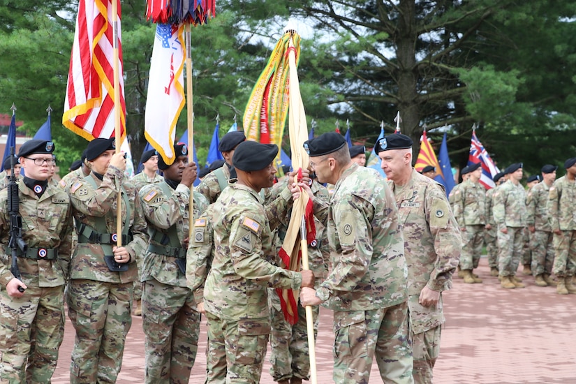 Lt. Gen. Terry R. Ferrell, commanding general, U.S. Army Central, passes the colors to Maj. Gen. Michel M. Russell Sr., incoming commanding general, 1st Theater Sustainment Command, during a change of command ceremony held July 13, 2021 outside Fowler Hall at Fort Knox, Kentucky. The passing of the colors from an outgoing commander to an incoming commander ensures that the unit and its Soldiers are never without official leadership, represents a continuation of trust, and signifies an allegiance of Soldiers to their unit's commander. (U.S. Army photo by Spc. Zoran Raduka)