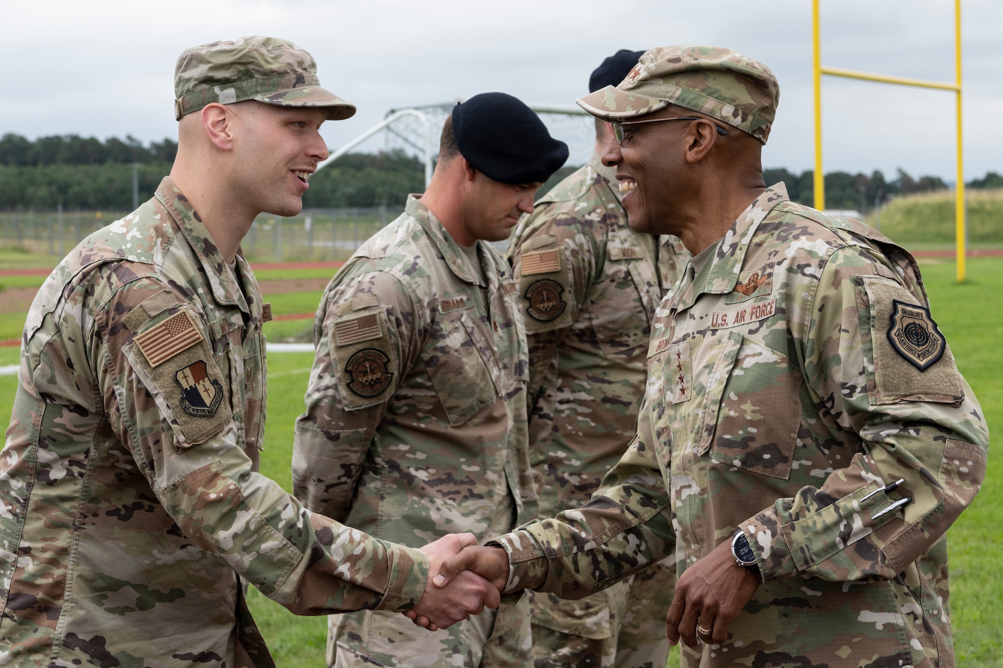 U.S. Air Force Chief of Staff Gen. CQ Brown Jr. (right) presents a challenge coin to U.S. Air Force Tech. Sgt. Kyle Weik, 52nd Munitions Maintenance Group chief inspector of quality assurance, July 16, 2021, on Spangdahlem Air Base, Germany.