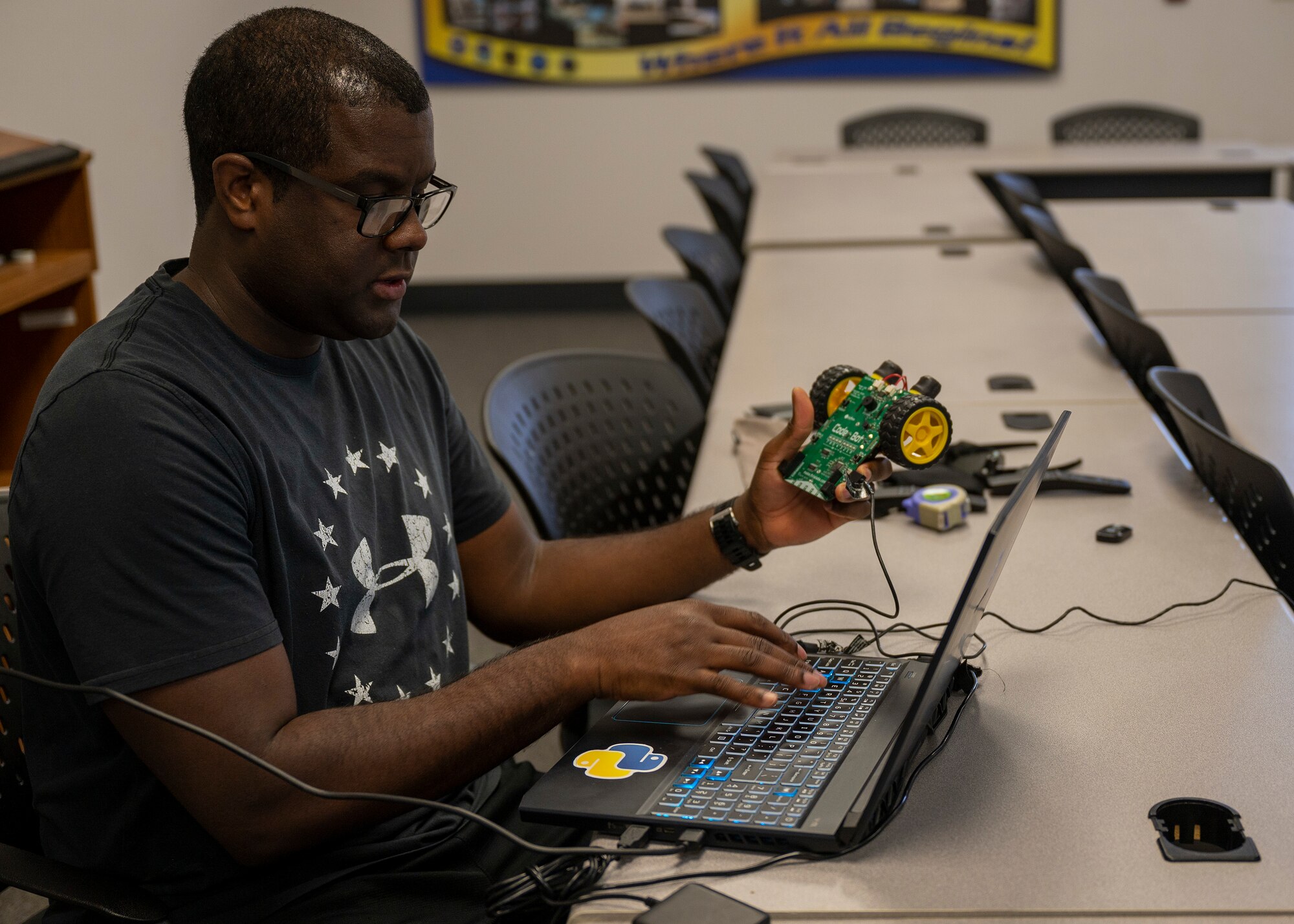 Master Sgt. Jason D. Greenwell, career assistance advisor, 412th Test Wing, programs a small robot during a Code Bot Course that was offered at Edwards Air Force Base, May 13. Project Code Bot graduated 10 remote students in May 2021 and is slated to conduct the next class August 16-20. The Code Bot Course was made available through SparkEd. In the summer of 2019, the 412th TW stood up SparkED, an official AFWERX-recognized Spark Cell for Edwards AFB.