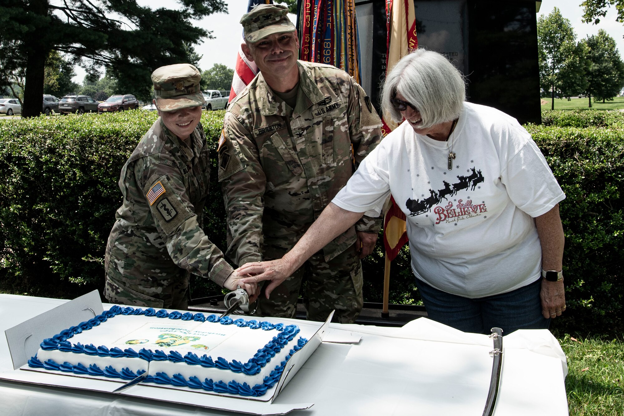 Photos of soldiers cutting a cake.