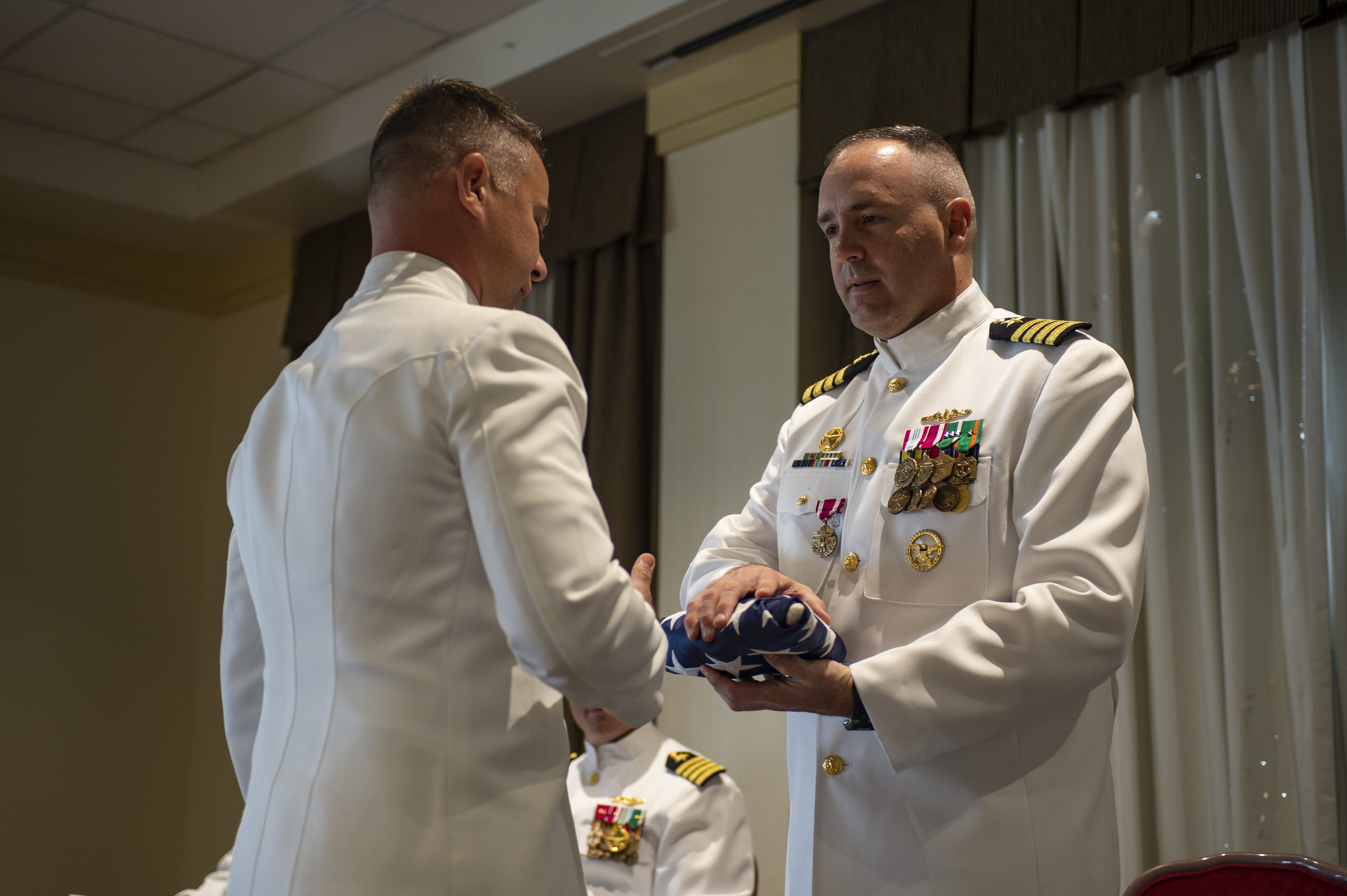 Cmdr. Jon Quimby, left, relieves Capt. Michael Delaney as commanding officer of the Virginia-class fast-attack submarine Pre-Commissioning Unit (PCU) Montana (SSN 794) during a change of command ceremony at Naval Station Norfolk, July 16, 2021.