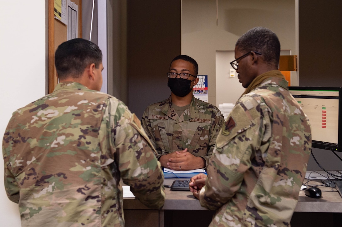 A photo of a group of Airmen speaking.