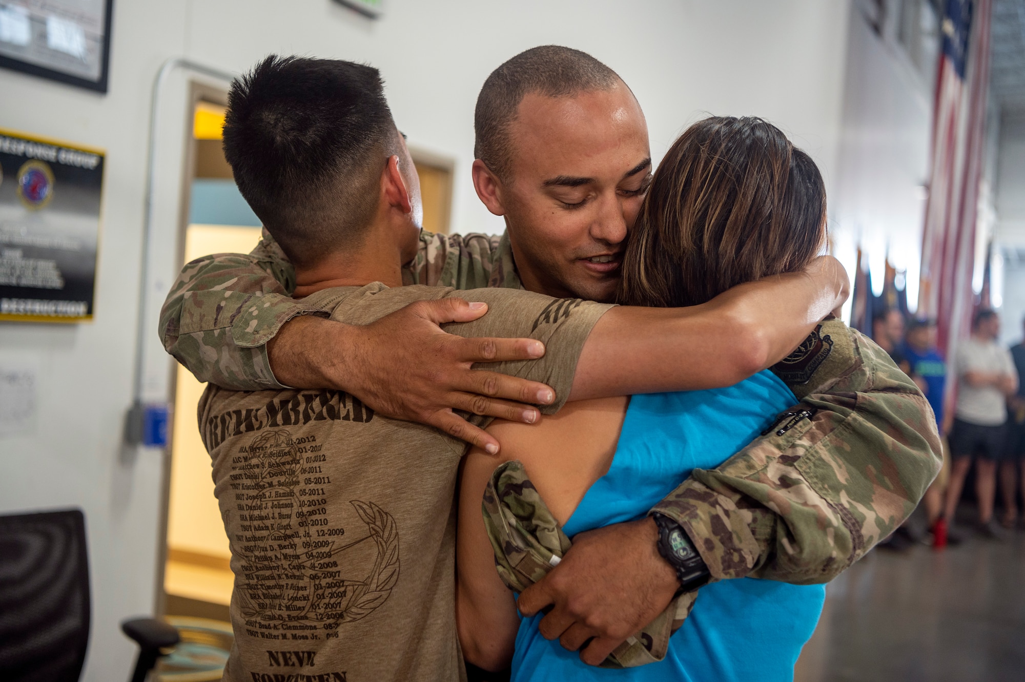 Senior Airman Laurence Pierre, 921st Contingency Response Squadron defender, hugs friends after arriving to the Global Reach Deployment Center June 19, 2021, at Travis Air Force Base, California. Devil Raiders supported retrograde operations in the Central Command area of responsibility as part of Task Force 74. (U.S. Air Force photo by Master Sgt. David W. Carbajal)