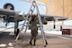 A photo of an airman carrying a ladder