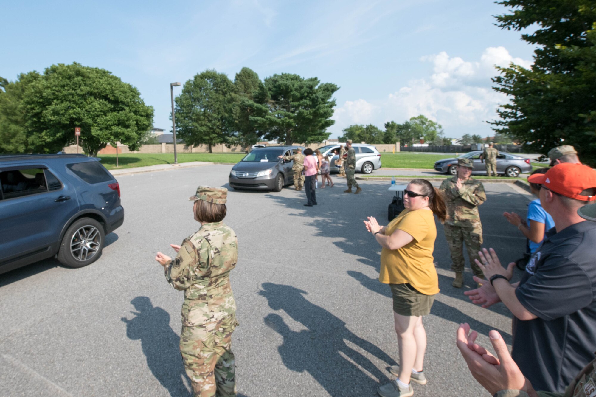 Members of Team Dover greet and cheer for spouses and families of deployed service members at the deployed families dinner on Dover Air Force Base, Delaware, July 15, 2021. Groups from across the 436th Airlift Wing take turns hosting the quarterly event to give thanks to family members while their loved ones are deployed. (U.S. Air Force photo by Mauricio Campino)