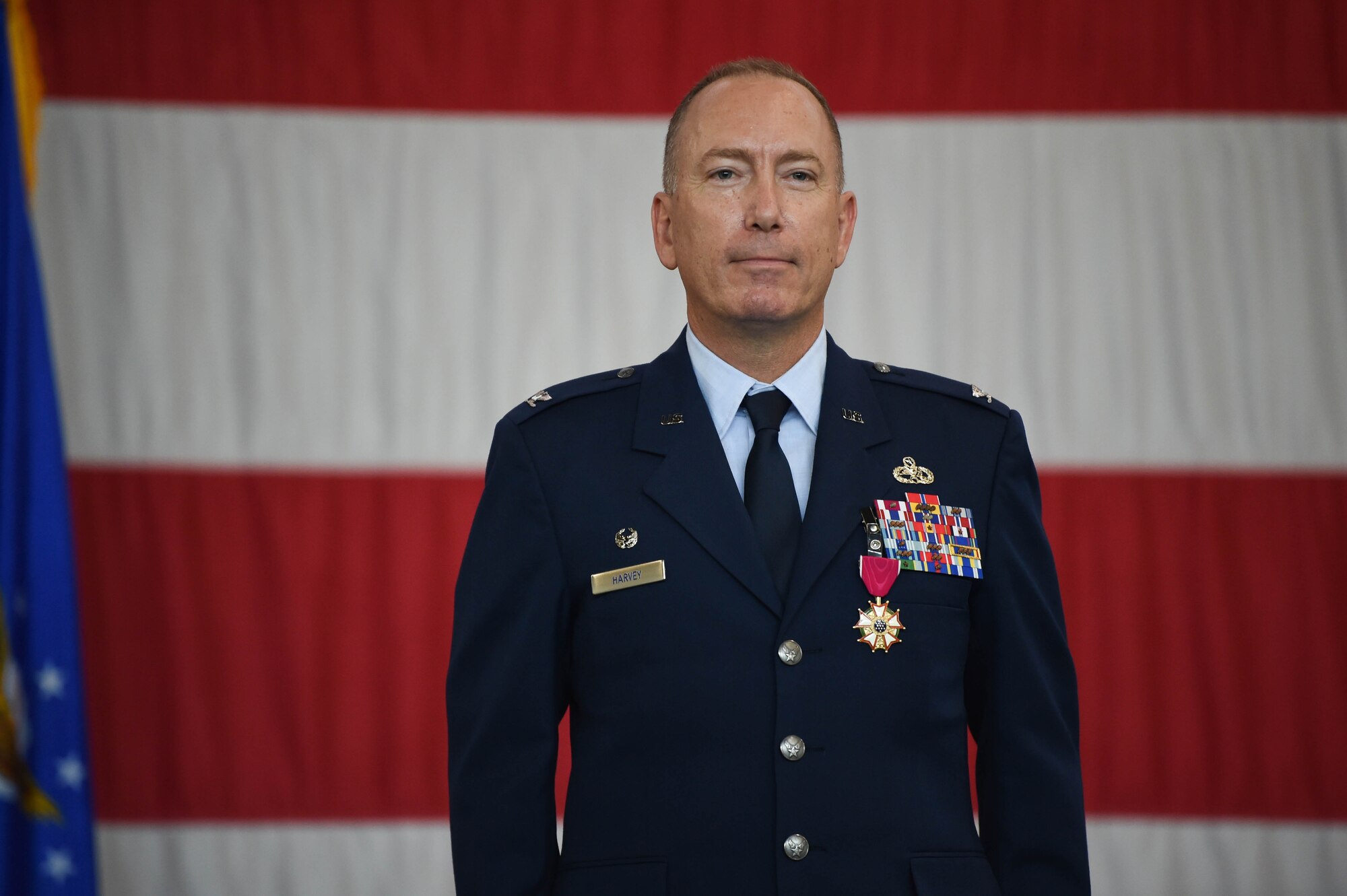 A photo of a commander standing on a stage