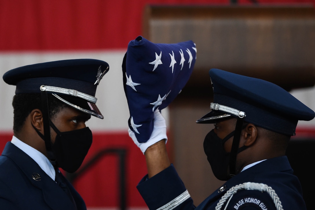 A photo of an honor guardsman holding a folded flag