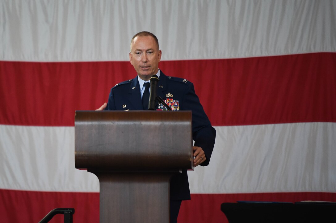 A photo of a commander speaking at a podium