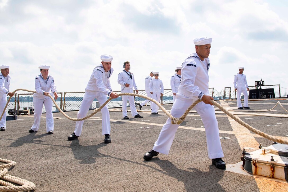 Sailors pull a rope.