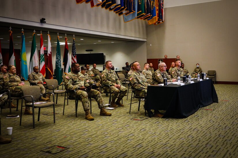 U.S. Army Central Command Sgt. Maj. Brian Hester and staff Sgts. Maj. listen as someone speaks during the USARCENT Land Forces NCO Symposium, July 14, 2021 in the Lucky Conference Room at USARCENT headquarters on Shaw Air Force Base, S.C. This annual symposium was held to solidify relationships and increase the capacity of professionalism of our partner nations NCO Corps. (U.S. Army photo by Spc. Keon Horton)