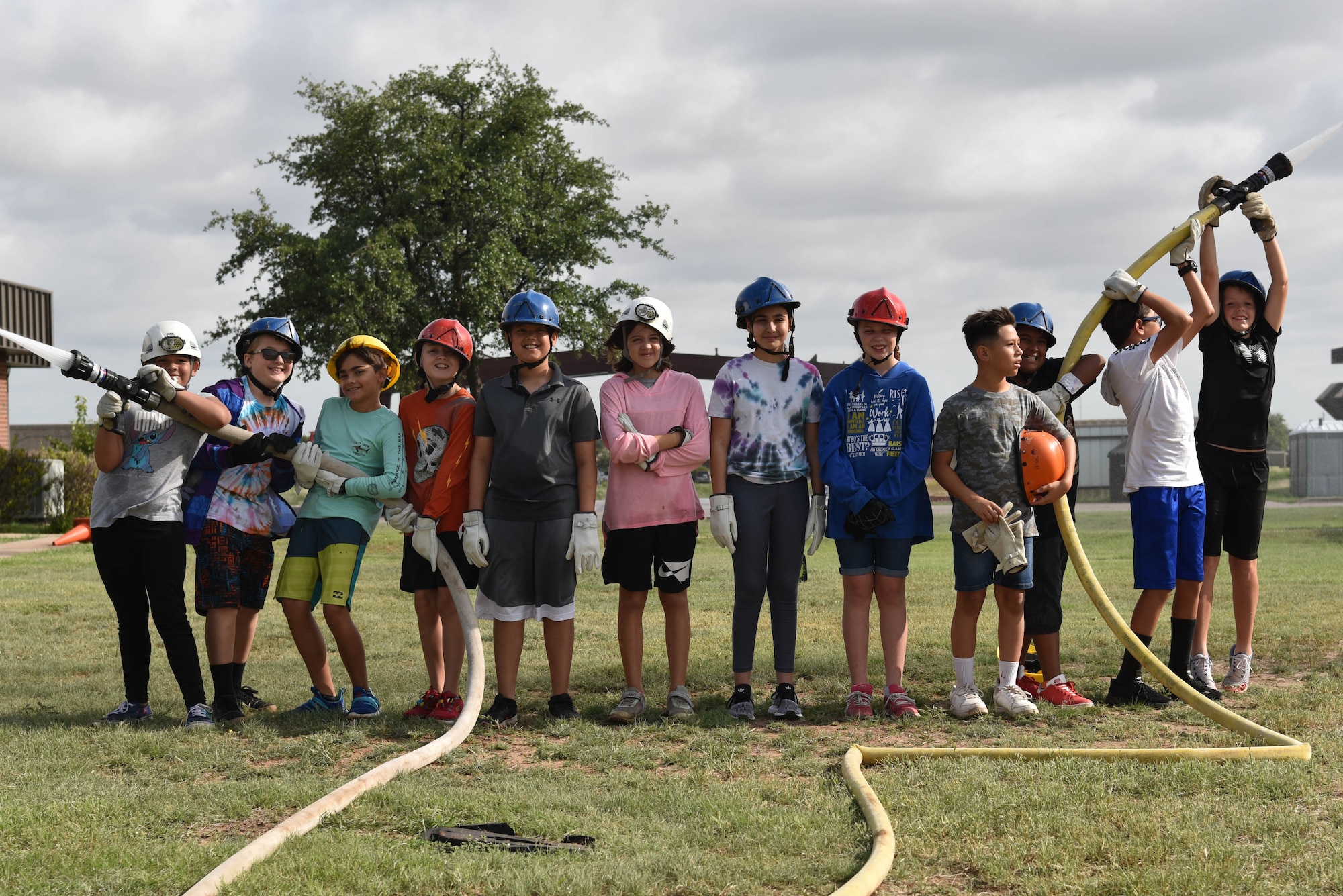 Junior firefighters pose for a photo during the junior firefighter camp on Goodfellow Air Force Base, Texas, July 15, 2021. There were 12 junior firefighters that participated in this year’s camp, ranging from ages 10 to 12. (U.S. Air Force photo by Senior Airman Jermaine Ayers)