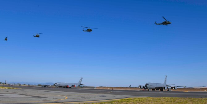 Airmen from the 36th Rescue Squadron fly four UH-1N Hueys in formation over KC-135 Stratotankers on Fairchild Air Force, Washington, July 16, 2021. The UH-1N’s were flown in the order the 36th RQS received them. Leading the formation was tail 6648, a 50-year-old helicopter with nearly 20,000 service hours. (U.S. Air Force photo by Airman 1st Class Kiaundra Miller)