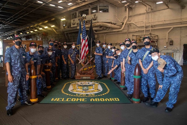 National Defense Academy of Japan cadets pose for a photo during a ship tour aboard the amphibious transport dock ship USS Green Bay (LPD 20).