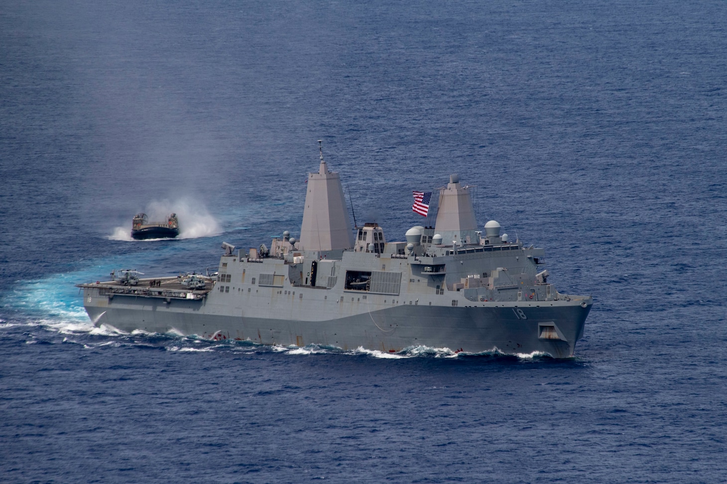 PHILIPPINE SEA (June 13, 2021) Amphibious transport dock USS New Orleans (LPD 19), right, sails alongside a Japan Maritime Self Defense Force landing craft, air cushion. The America Amphibious Ready Group, along with the 31st Marine Expeditionary Unit, is operating in the U.S. 7th Fleet area of operations to enhance interoperability with allies and partners and serve as a ready response force to defend peace and stability in the Indo-Pacific region.