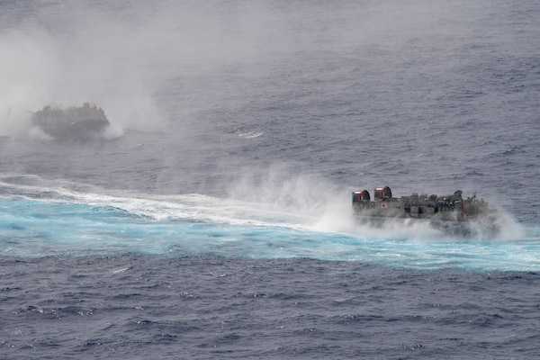 PHILIPPINE SEA (June 13, 2021) Two landing craft, air cushion from the Japan Maritime Self Defense Force sail alongside the America Amphibious Ready Group (ARG) during bilateral operations. The America ARG, along with the 31st Marine Expeditionary Unit, is operating in the U.S. 7th Fleet area of operations to enhance interoperability with allies and partners and serve as a ready response force to defend peace and stability in the Indo-Pacific region.