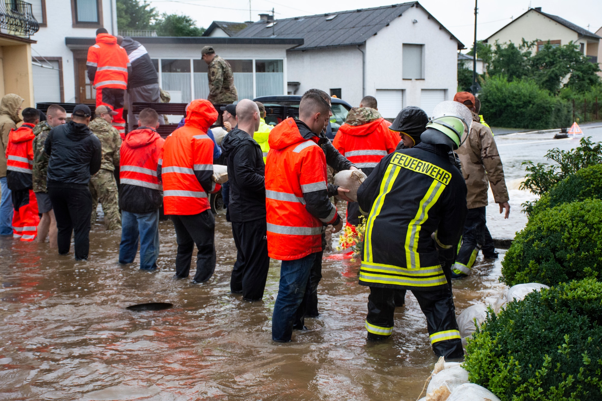 Members from the 52nd Civil Engineering Squadron work with German first responders and community members to quickly lay hundreds of sandbags throughout the town of Binsfeld, Germany, July 14, 2021.