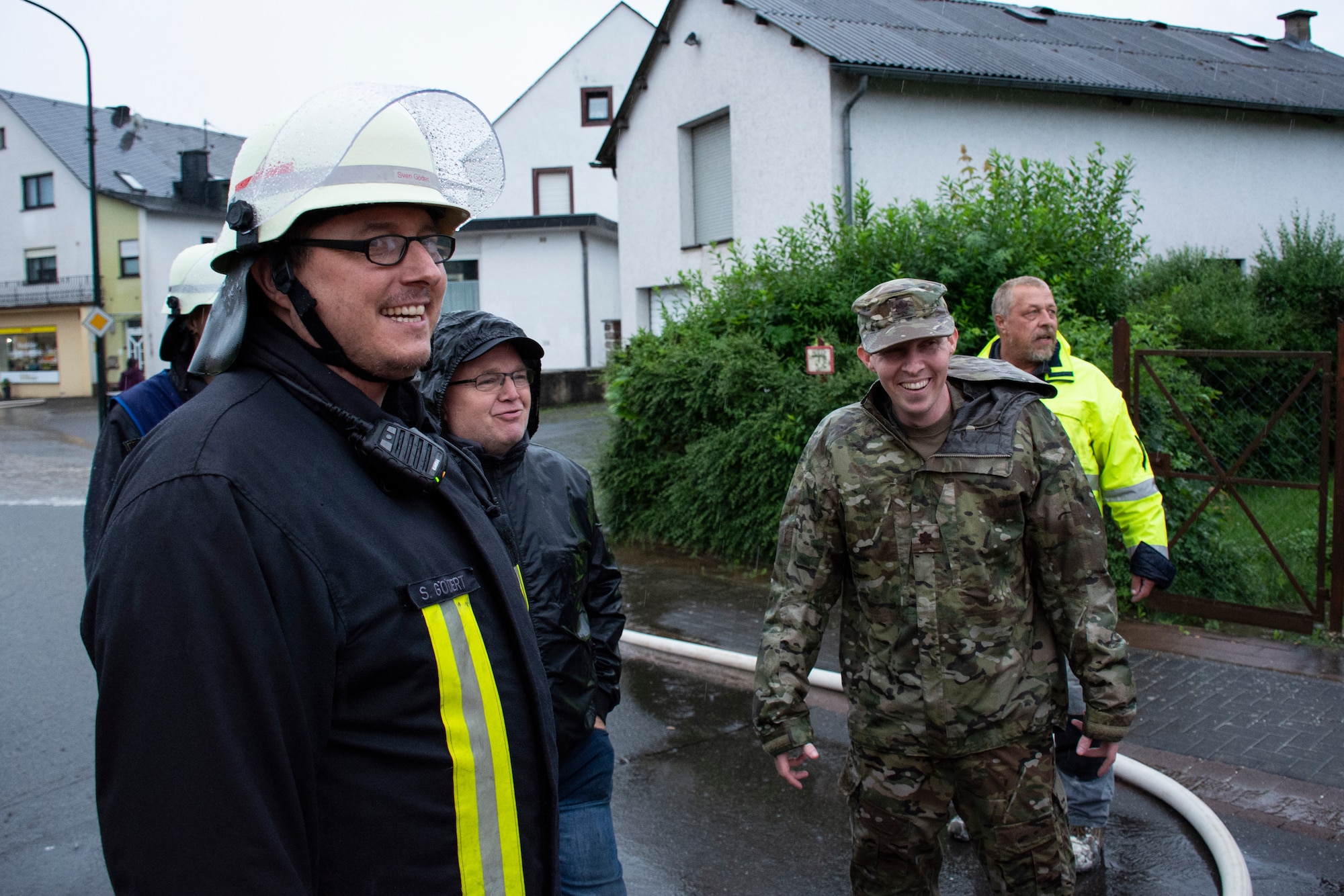 U.S. Air Force Maj. Daniel Blomberg, 52nd Civil Engineer Squadron Operations Flight commander from Spangdahlem Air Base, Germany (center right), works with German first responders to clear water from local residences in Binsfeld, Germany, July 14, 2021.