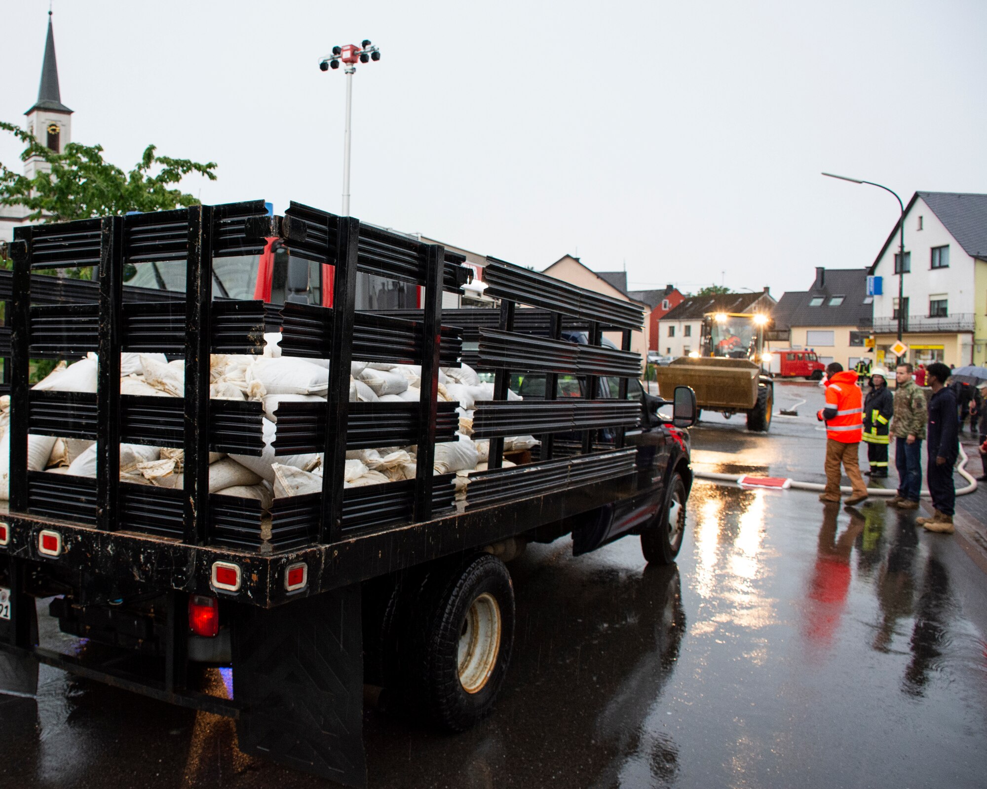 Members from the 52nd Civil Engineer Squadron from Spangdahlem Air Base, Germany, arrive in Binsfeld, Germany, to deliver sandbags after flood waters threatened homes and businesses in the town July 14, 2021.