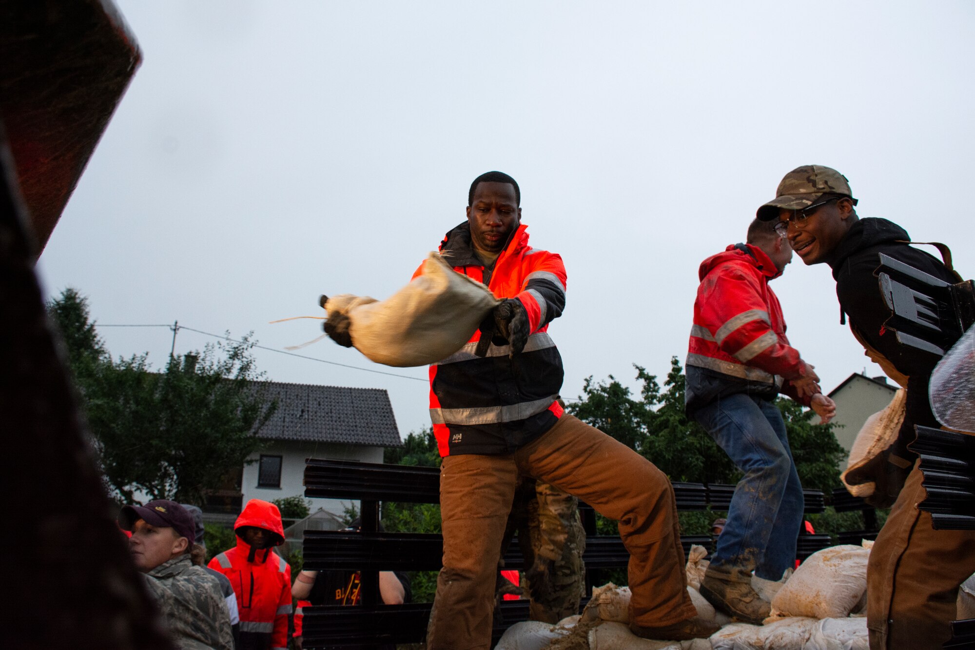 Members from the 52nd Civil Engineer Squadron from Spangdahlem Air Base, Germany, work with German first responders and community members to lay sandbags in the town of Binsfeld, Germany, July 14, 2021.