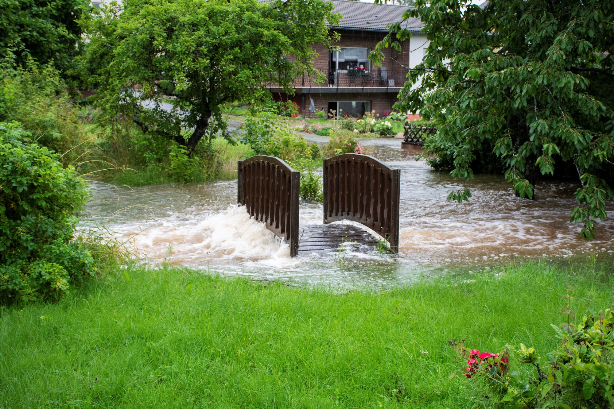 Water surges in the village of Binsfeld, Germany, near Spangdahlem Air Base, Germany, July 14, 2021.