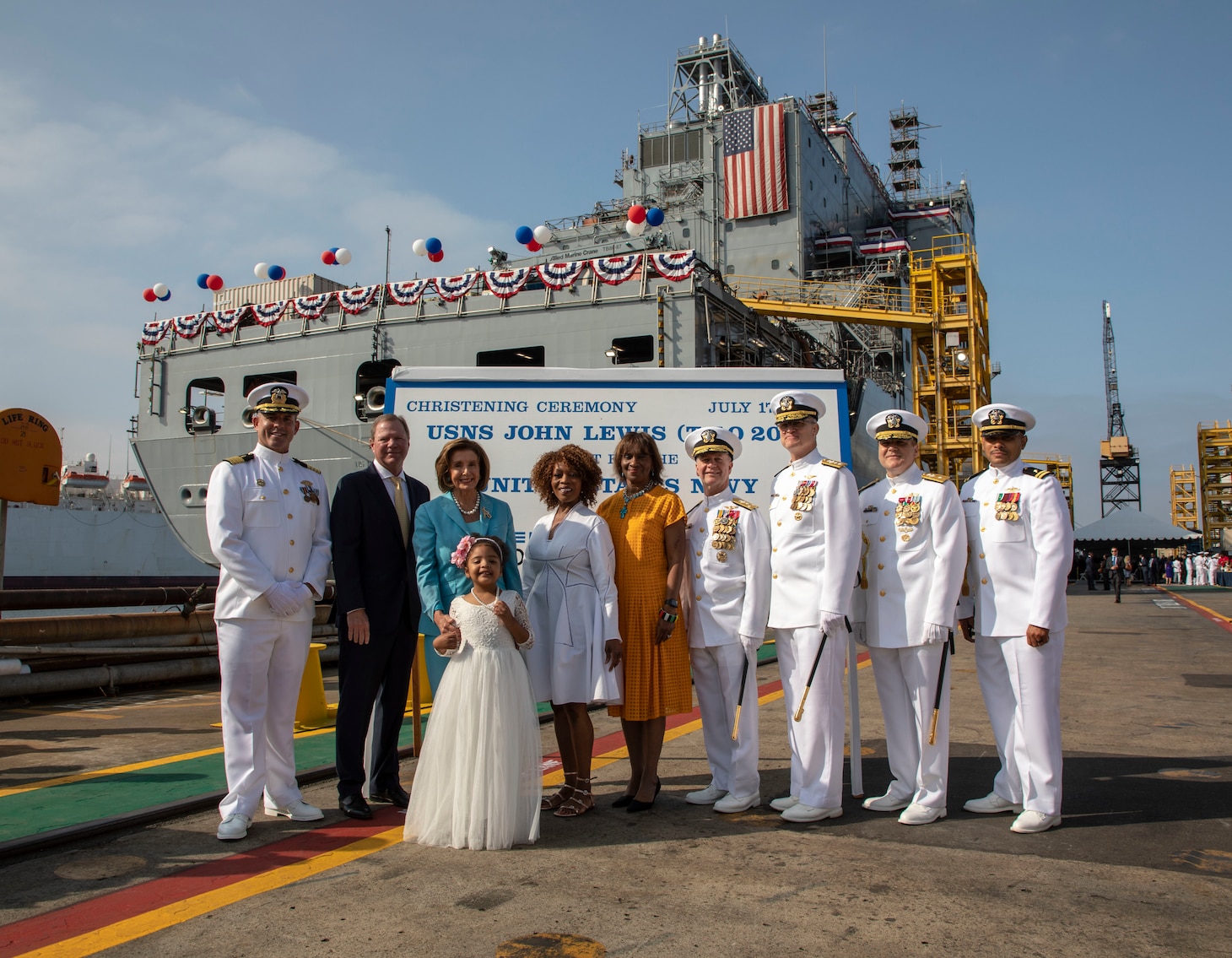 The official party pose for a photograph at the commissioning ceremony in San Diego for the future USNS John Lewis (T-AO 205), the Navy’s first John Lewis-class replenishment oiler.