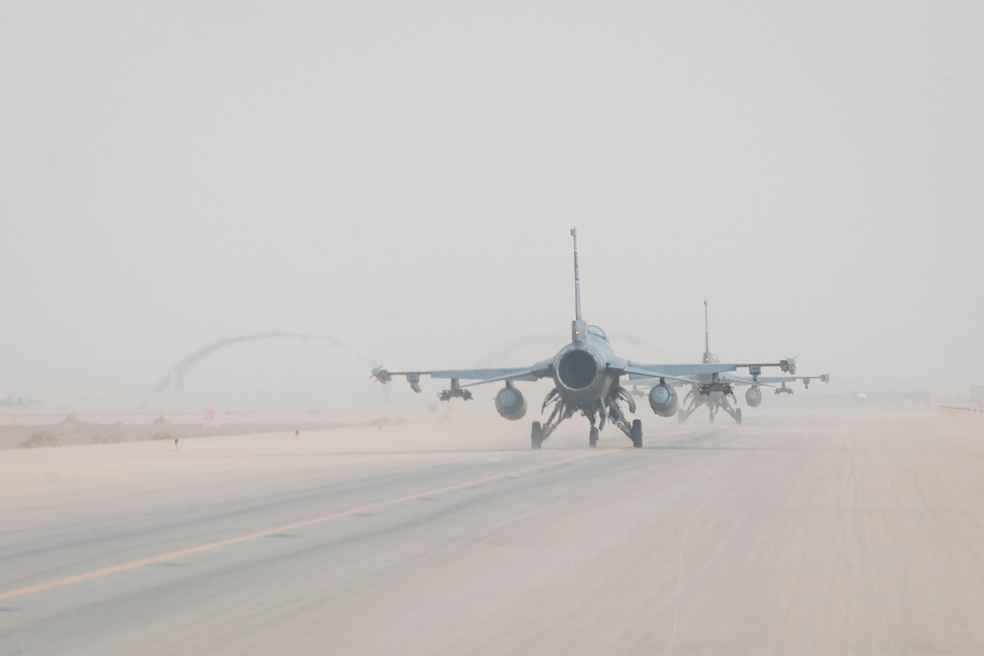 U.S. Air Force F-16 Fighting Falcons taxi in preparation for take-off during a partner nation integration mission with the Royal Saudi Air Force with the Royal Saudi Air Force at Prince Sultan Air Base, Kingdom of Saudi Arabia, June 17, 2021. U.S. Air Forces Central aircraft regularly work with coalition and partner nations to test their collective counter-UAS capabilities to ensure the security and stability of regional airspace. (U.S. Air Force photo by Staff Sgt. Caleb Pavao)