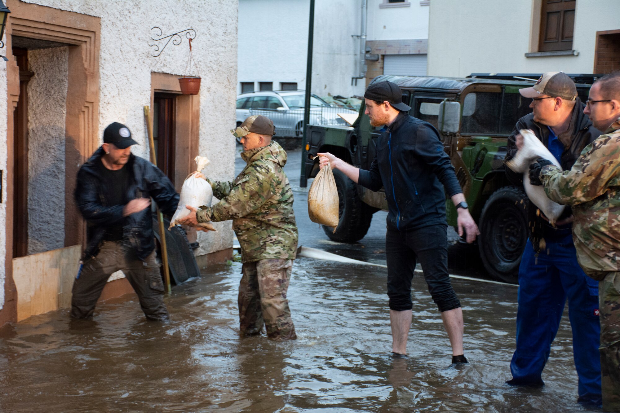 Members from the 52nd Civil Engineer Squadron from Spangdahlem Air Base, Germany, work with German first responders and community members to lay sandbags in the town of Binsfeld, Germany, July 14, 2021.