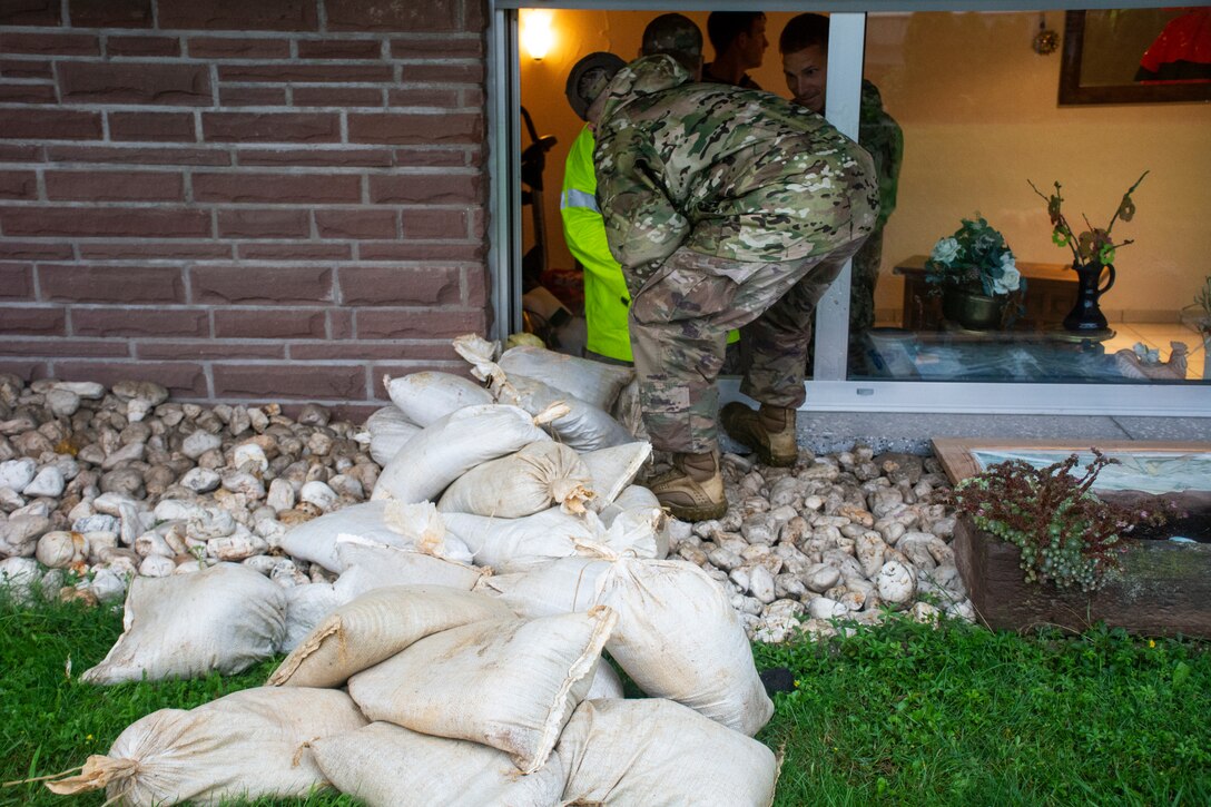 U.S. Air Force members from the 52nd Civil Engineer Squadron from Spangdahlem Air Base, Germany, work with German first responders and community members to deliver sandbags to the town of Binsfeld, Germany, July 14, 2021.